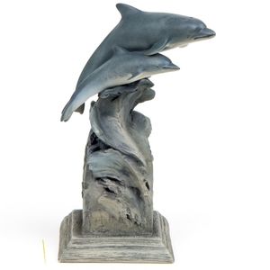 Dolphin sculpture dolphins riding a wave.